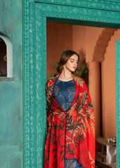 A woman wearing a lawn digital printed blue and red dress with chiffon dupatta, standing against a turquoise background.